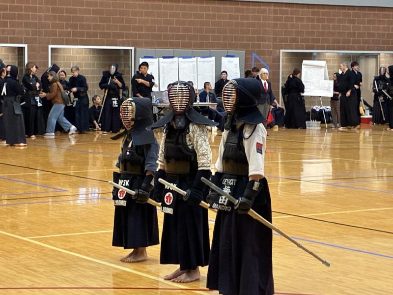 Image of Makoto Umeda wearing kendo gear and lining up with teammates at Johnson Cup Tournament