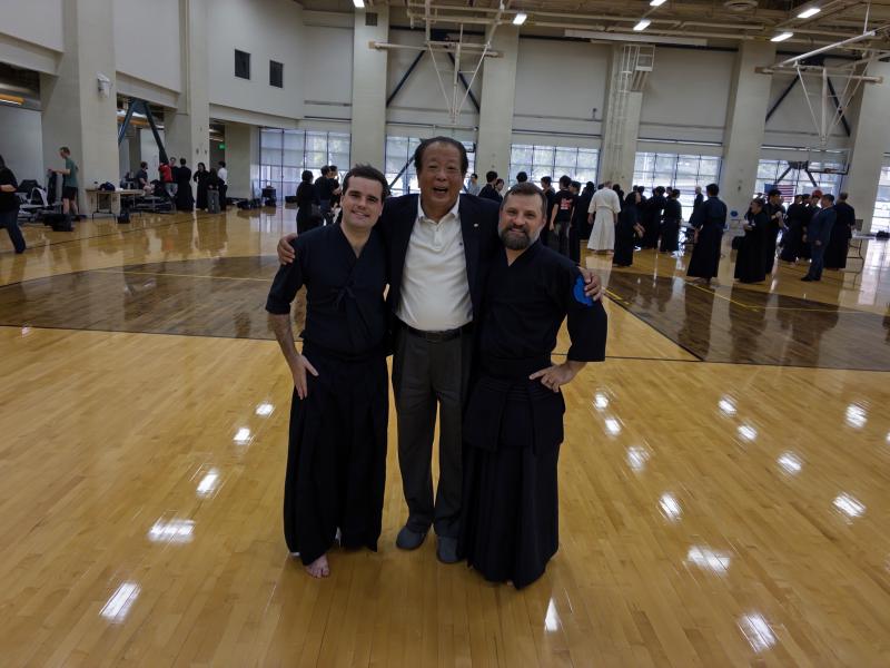 Image of Tagawa-sensei with two members that passed their ranking exam